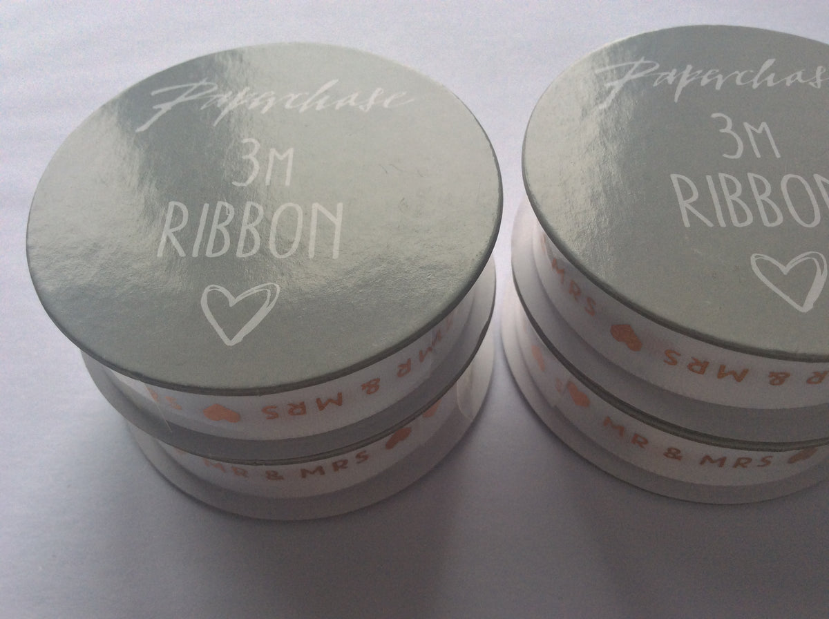 Six Paperchase white wedding ribbon rolls with gold Mr and Mrs lettering