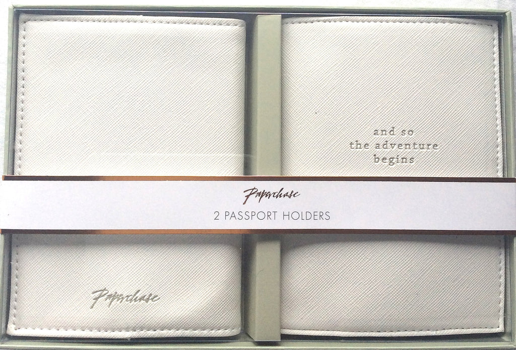 Two light-coloured textured passport holders shown in their presentation box