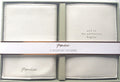 Two light-coloured textured passport holders shown in their presentation box