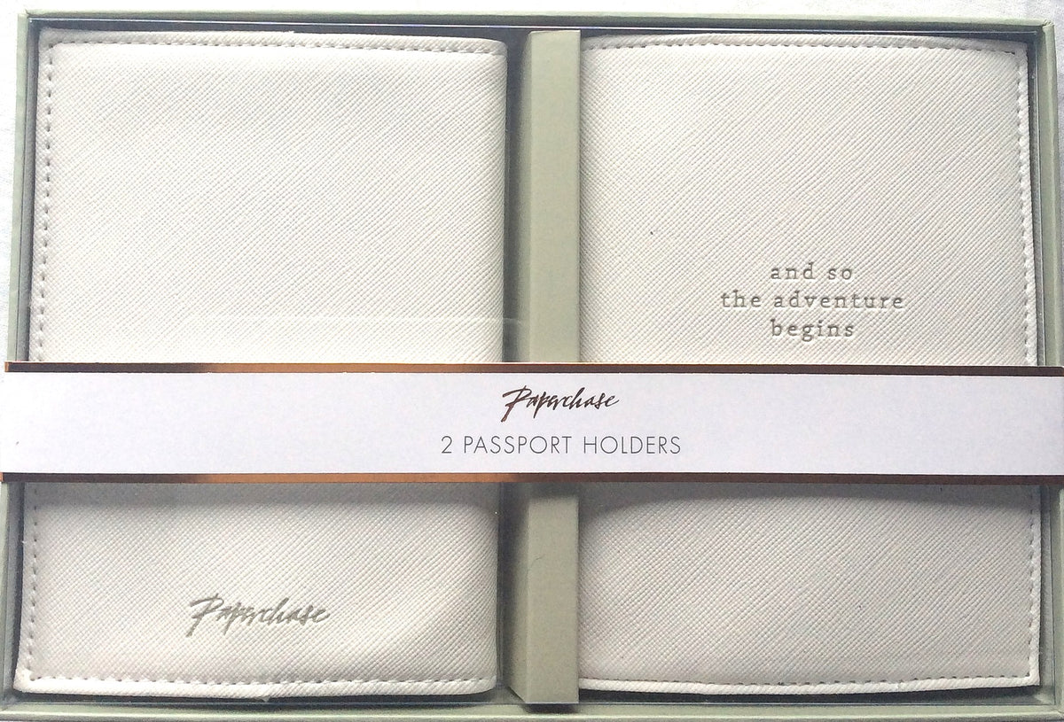 Two light-coloured textured passport holders shown in their presentation box