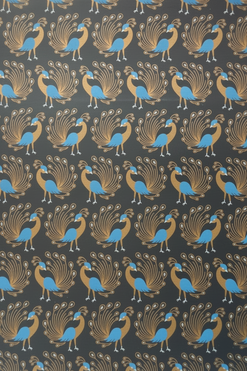 A roll of fabric with a repeating peacock pattern on a dark charcoal background. The peacocks are detailed in gold and bright blue.