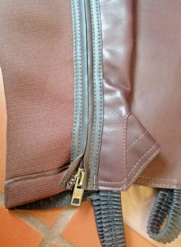 Original photograph of brown ProChaps half chaps and packaging
