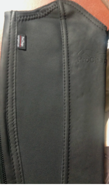 Close-up of the black leather ProChaps Competition half chaps zip and elastic foot strap