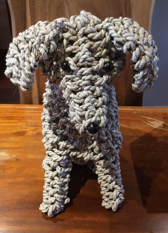 Handmade rope dog sculpture from the rear showing natural mendong rope weaving