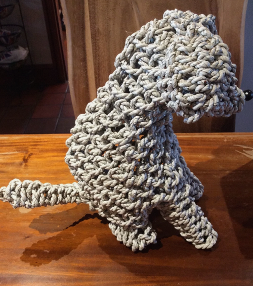 Handmade rope dog sculpture viewed from the side showing rope texture and tail